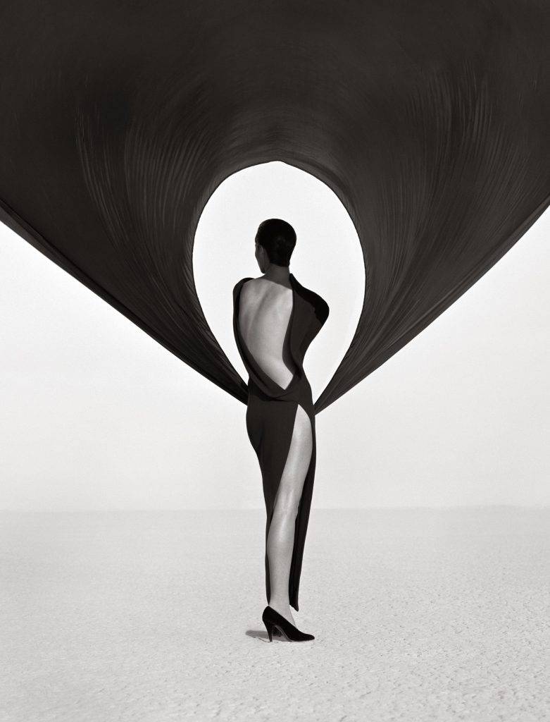 Herb Ritts, “Versace Dress (Back View), El Mirage” (1990). © Herb Ritts Foundation. Courtesy of Fahey Klein Gallery, Los Angeles.