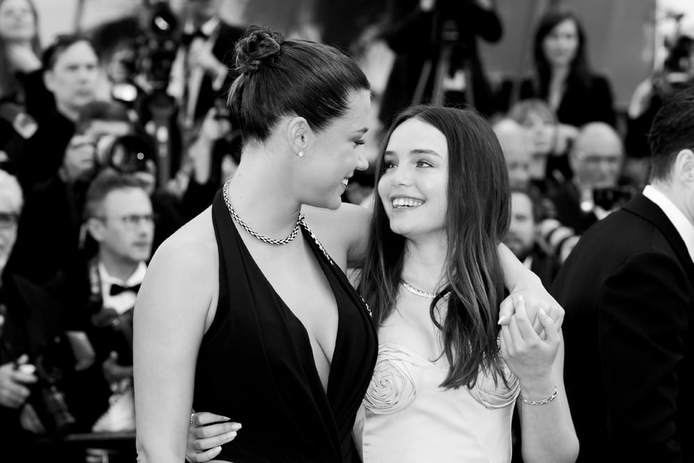 Mallory Wanecque and Adele Exarchopoulos attend the "L'Amour Ouf" (Beating Hearts) Red Carpet at the 77th annual Cannes Film Festival at Palais des Festivals on May 23, 2024 in Cannes, France. (Photo by Stephane Cardinale - Corbis/Corbis via Getty Images)