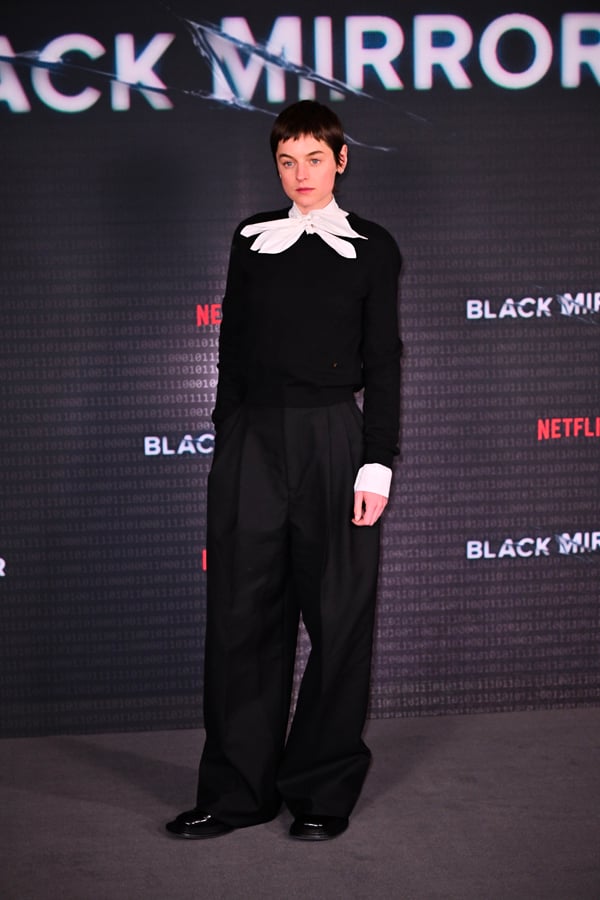 Emma Corrin in a black and white Moschino outfit © Photo by Jed Cullen/Dave Benett/WireImage.