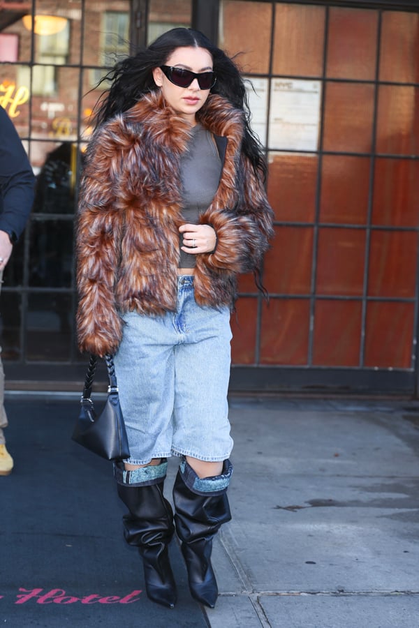 Charli xcx in denim bermuda shorts, jacket and black boots. © Photo by Aeon/GC Images.