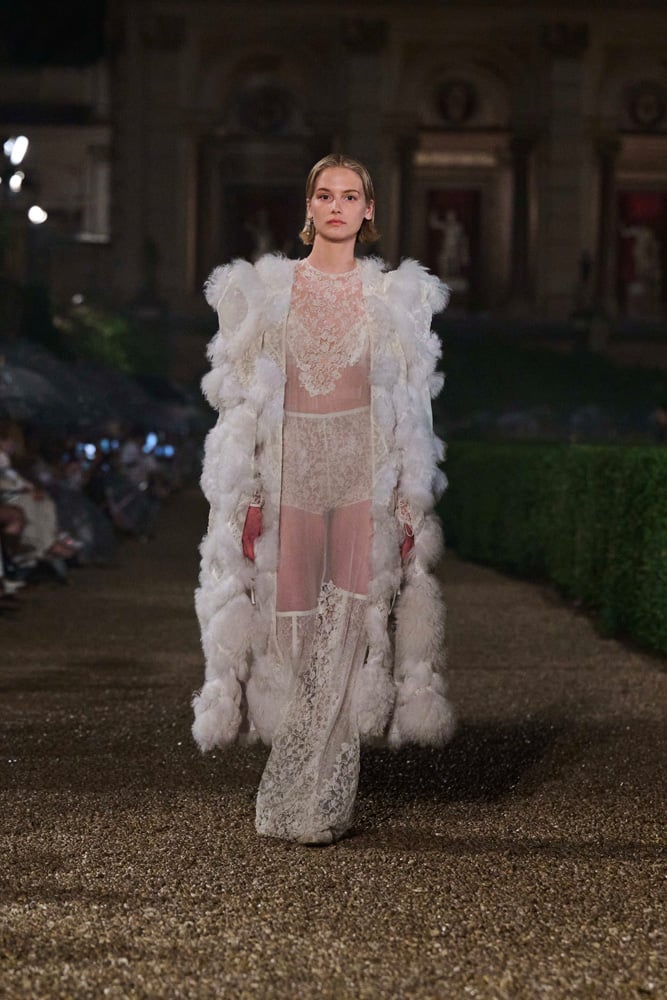 Dior Cruise 2026 white, see-through lace ensemble with fur jacket