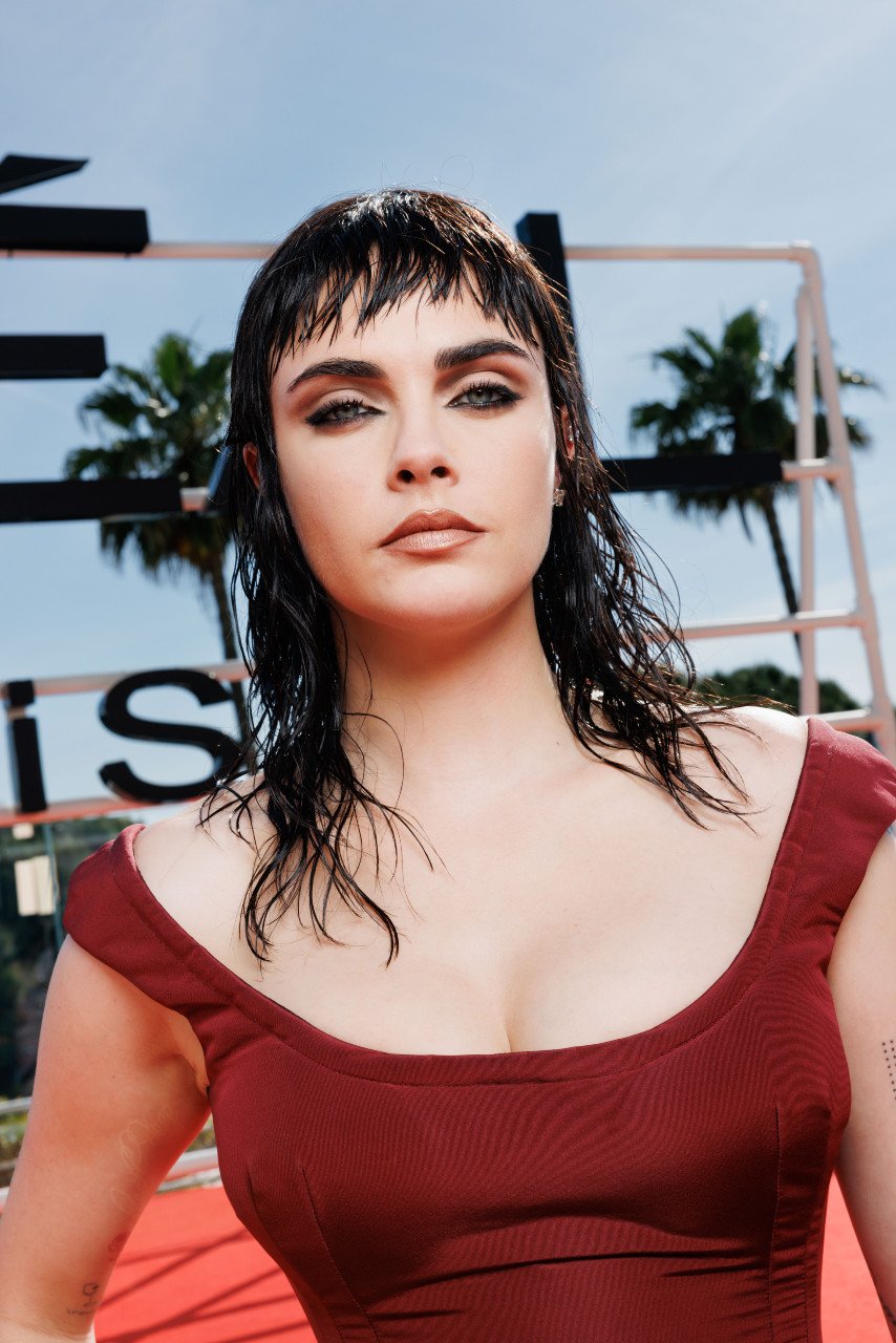 Cara Delevigne wearing a burgundy dress at the 2025 Cannes Film Festival