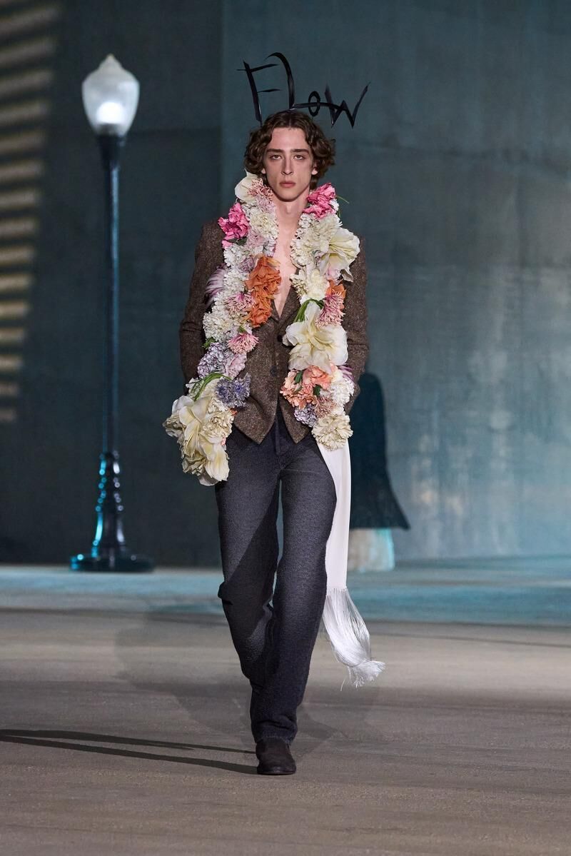 veste en tweed et jean homme avec echarpes de fleurs du défilé Dior Cruise 2027 à Los Angeles.